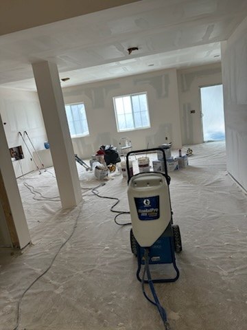 Large open floor plan with fresh drywall hung, taped and finished